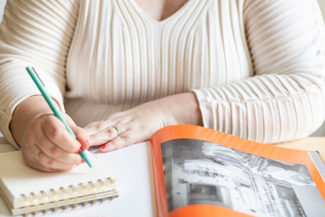 woman writing in notebook